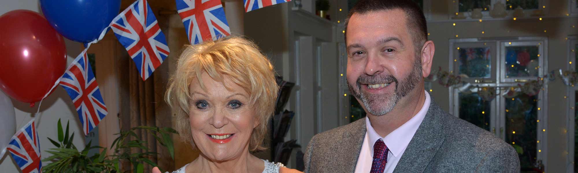 Merlin Court Care Home Marlborough Sherrie Hewson celebrity visit best of British union flag balloon banner hero