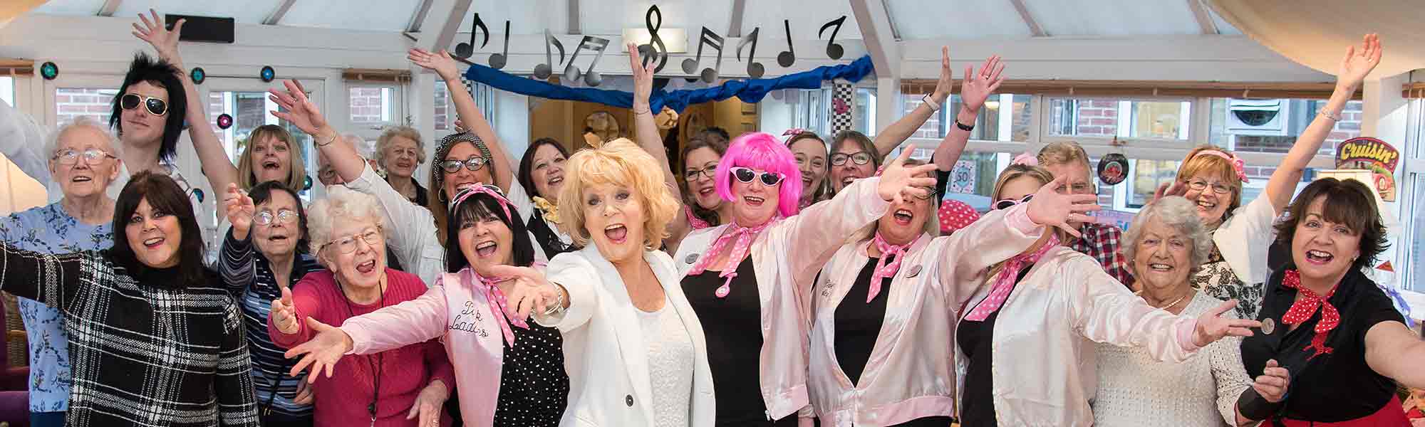 Loxley Park Assisted Living 1950s rockabilly pink ladies sherrie hewson staff celebrate banner hero