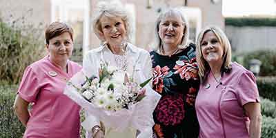 Acacia Mews Care Home Hatfield Sherrie Hewson Staff flowers smiling posed photo