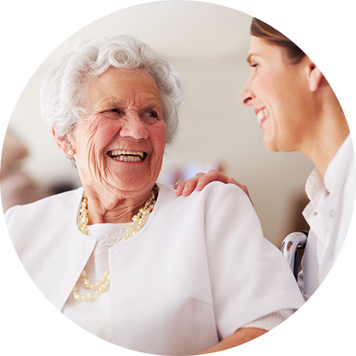 A smiling resident and care worker